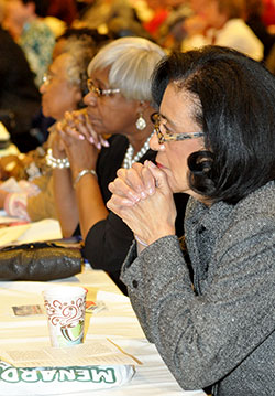 Aster Bekele, a member of St. Rita Parish in Indianapolis, left, Franciscan Sister Jeannette Pruitt, center, and Janice Slaughter, a member of St. Monica Parish in Indianapolis, front, listen during the Indiana Catholic Women&rsquo;s Conference on March 21 in Indianapolis. (Photo by Natalie Hoefer)