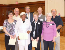 Among those recognized for years of service during the Catholic Charities&rsquo; volunteer dinner on April 13 at the Archbishop Edward T. O&rsquo;Meara Catholic Center in Indianapolis are, front row, Karen Boyer, left, (10 years); Florine Harrington (10 years); Linda Hegeman (five years); and Fran Doyle (10 years). Second row: Richard Moore (10 years); David Bethuram, agency director of Catholic Charities Indianapolis; Jim Schutter (five years); and Ed Doyle (10 years). Not pictured is Jane Keller, who was recognized for five years of volunteer service. (Photo by Mike Krokos)