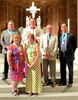 Archbishop Joseph W. Tobin poses for a photo with the 2015 recipients of the St. John Bosco Award, the highest honor of the archdiocese&rsquo;s Catholic Youth Organization. The recipients in the front row are Marni Fey, left, and Amy Stimpson. The recipients in the back row are Ken Troy, left, John Kistner and Steve Battiato. The recipients received their awards on May 6 in the SS. Peter and Paul Cathedral in Indianapolis. (Submitted photo)
