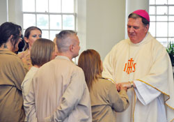 Inmates at the Indiana Women&rsquo;s Prison in Indianapolis line up to meet Archbishop Joseph W. Tobin as he greets Alicia Brown after a Mother&rsquo;s Day Mass he celebrated at the prison on May 10. (Photo by Natalie Hoefer)