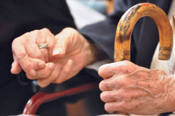 A couple holds hands during the Golden Wedding Jubilee Mass at SS. Peter and Paul Cathedral in Indianapolis on Sept. 21, 2014. The growing number of marriages in the archdiocese lasting 50 or more years&mdash;plus the desire to recognize all marriages&mdash;led the archdiocesan Office of Pro Life and Family Life to focus the annual Golden Wedding Jubilee Mass on those celebrating their 50th anniversary, and a separate Mass to honor all married couples, with special recognition given to those married for 60 or more years. (File photo by Natalie Hoefer)