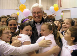 Father James Wilmoth&rsquo;s popularity with the students at St. Roch School in Indianapolis is evident during a schoolwide tribute to him in 2010, shortly after he received the Distinguished Pastor Award from the National Catholic Educational Association. (File photo by John Shaughnessy)