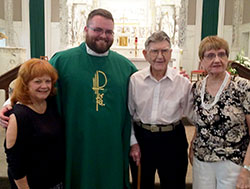 At 103, Tom Horn has always kept moving, except when it comes to his place of worship. He has been a member of St. Augustine Parish in Jeffersonville all his life. He poses in the parish church on Father&rsquo;s Day of this year with Father Douglas Marcotte, administrator of St. Augustine Parish, and two of his nieces, Sharon Horn, left, and Jerri Brandenburg. (Submitted photo)