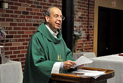 Baltimore Archbishop William E. Lori gives a homily during a July 18 Mass at a Knights of Columbus hall in New Albany during a celebration with some of his classmates of the 50th anniversary of their graduation from the eighth grade at Our Lady of Perpetual Help School, also in New Albany. Prior to the Mass, Archbishop Lori, who is chairman of the U.S. bishops&rsquo; Ad Hoc Committee for Religious Liberty, spoke with The Criterion about recent changes in the religious liberty landscape in America. (Photo by Sean Gallagher)