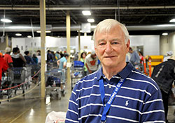 In the midst of another busy day at the Indianapolis food pantry of the Society of St. Vincent de Paul, John Ryan leads the all-volunteer group&rsquo;s efforts to help people escape the cycle of poverty. (Photo by John Shaughnessy)