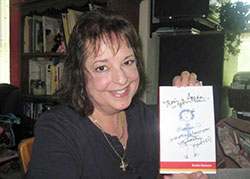 St. Mark the Evangelist School teacher Evelyn Karozos is pictured with a copy of her book, There&rsquo;s a Spider in Your Hair (and other classroom vignettes). (Submitted photo)