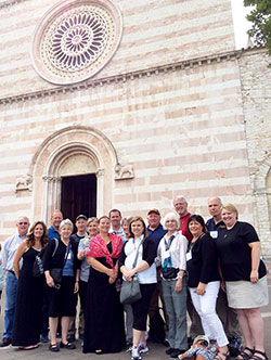 Pilgrims from Marian University in Indianapolis stand in front of the Basilica di Santa Chiara in Assisi, Italy, which houses St. Clare&rsquo;s remains and the original San Damiano Crucifix. (Submitted photo)
