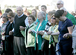Participants in the Indy Irish Fest hold hands during the praying of the &ldquo;Our Father&rdquo; at the Sunday Mass, a tradition that begins the last day of the festival which is on Sept. 17-20 this year at Military Park in Indianapolis. (Submitted photo) 