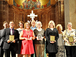 Five individuals were honored by the archdiocese on Sept. 2 during the Administrators&rsquo; Mass at SS. Peter and Paul Cathedral in Indianapolis. The honorees, all in the front row, are Andrew Costello, left, John Paul II Young Adult Servant Leader Award recipient; Amy Wilson, St. Theodora Excellence in Education Award winner; Julie Haney, Excellence in Catechesis Award recipient; and Carol Wagner and Patty Cain, who both received the Youth Ministry Servant Leader of the Year Award. In the back row are Matt Faley, left, director of young adult and college campus ministry for the archdiocese; Gina Fleming, superintendent of Catholic schools for the archdiocese; Ken Ogorek, director of catechesis for the archdiocese; and Kay Scoville, director of youth ministry for the archdiocese. (Photo by John Shaughnessy)