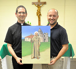 Father Eric Augenstein and Michael McCarthy hold a painting of St. Junipero Serra in the St. Alphonsus Liguori Chapel in the Archbishop Edward T. O&rsquo;Meara Catholic Center in Indianapolis. The painting, created by McCarthy, was commissioned by the archdiocesan Vocations Office and the Indianapolis Serra Club. It will be used on prayer cards and posters to promote priesthood and religious vocations. (Photo by Sean Gallagher)