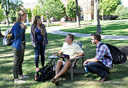 Madison Kinast, left, leader of the Fellowship of Catholic University Students (FOCUS) team at DePauw University in Greencastleand FOCUS team member James Marra, far right, talk with DePauw students Mary Ann Etling and Grant Potts on the university&rsquo;s campus on Sept. 21. (Photo by Natalie Hoefer)