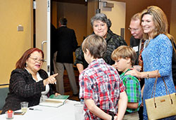 Alveda King, niece of the Rev. Martin Luther King, Jr., left, shares a story with the grandchildren of Cindy Noe, standing at left, before signing a copy of her book at the Right to Life of Indianapolis &ldquo;Celebrate Life&rdquo; dinner in Indianapolis on Sept. 29. During the dinner, Noe received Right to Life of Indianapolis&rsquo; Respect for Life Award. (Photo by Natalie Hoefer) 