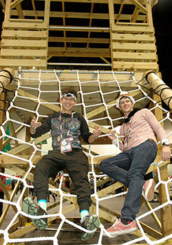 Jacob Riley, left, and Quinton Bell, both members of St. Ambrose Parish in Anderson, Ind., in the Lafayette Diocese, pose on the rope net that is part of the tree house that was at the center of Camp Tekakwitha, NCYC&rsquo;s interactive theme park. (Photo by John Shaughnessy)