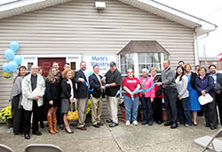 Staff, volunteers and supporters smile as the ribbon is cut during St. Elizabeth&rsquo;s Catholic Charities&rsquo; dedication of&nbsp;its new building to house Marie&rsquo;s Ministry, the agency&rsquo;s resource distribution center in New Albany. (Submitted photo by Patricia Happel Cornwell)