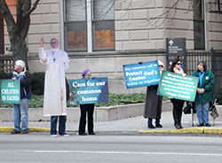 Catholic supporters of the United Nations climate change conference held in Paris on Nov. 30-Dec.11 hold signs in front of SS. Peter and Paul Cathedral in Indianapolis on Dec. 3 to raise awareness of Catholic support of the talks per Pope Francis&rsquo; call to care for creation in his encyclical, &ldquo;Laudato Si&rsquo;: On Care for our Common Home.&rdquo; (Photo by Natalie Hoefer)