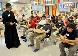 Father Martin Rodriguez, associate pastor of St. Monica Parish in Indianapolis, speaks about his call to the priesthood on Oct. 28 at Roncalli High School in Indianapolis with members of the school&rsquo;s freshman class. It was part of a day of reflection dedicated to vocations organized by Roncalli&rsquo;s campus ministry program. (File photo by Sean Gallagher)