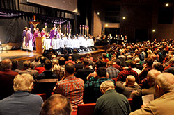 Hundreds of Catholic men kneel in prayer on March 5 at East Central High School in St. Leon while principal celebrant Archbishop Joseph W. Tobin and several concelebrating priests pray the eucharistic prayer during a Mass. The liturgy was part of the first &ldquo;E6 Catholic Men&rsquo;s Conference,&rdquo; which was organized by men who are parishioners of All Saints Parish in Dearborn County. (Photos by Sean Gallagher)
