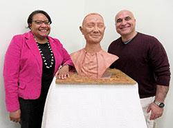 Dr. Cecilia A. Moore, featured speaker, and sculptor Guy Tedesco pose with Tedesco&rsquo;s clay bust of Cardinal Joseph E. Ritter, which was unveiled at the Cardinal Ritter House Irish coffee event in New Albany on March 14. The &ldquo;study bust&rdquo; will later be cast in bronze. (Photo by Patricia Happel Cornwell)