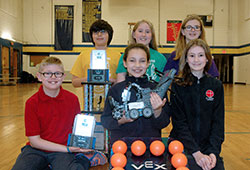 A robotics team at St. Thomas Aquinas School in Indianapolis is the only one from a Catholic school in Indiana to earn a place in the 2016 Vex Robotics World Championship in Louisville, Ky., on April 20-23. Members of the team in the first row are Bradley Basile, left, Maggie Gonzalez (holding the team robot &ldquo;Fluffy Sylvester&rdquo;) and Julia Dugan. Team members in the second row are Jackson Herrera, left, Grace Gerdenich and Maggie Timpe. (Photo by John Shaughnessy)