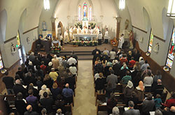 Annunciation Parish members and others from the Brazil faith community fill the church for the parish&rsquo;s 150th anniversary Mass on April 4. Archbishop Joseph W. Tobin was the principal celebrant of the Mass. He was joined by concelebrants and former pastors Fathers Harold Rightor, Stephen Jarrell, Robert Hausladen, and current pastor Father John Hollowell. Also concelebrating were Conventual Franciscan Father Martin Day, pastor of St. Benedict Parish in Terre Haute, and Father Michael Fritsch, previously an Annunciation parishioner. Loral Tansy, to the right of the archbishop, served as master of ceremonies. (Photo by Natalie Hoefer)