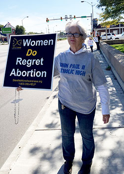 Judy Sweeney, a member of Sacred Heart of Jesus Parish in Terre Haute, holds a sign stating that women regret abortion during last year&rsquo;s Life Chain in Terre Haute on Respect Life Sunday on Oct. 4. The Archdiocese of Indianapolis offers many post-abortion healing ministries. (File photo submitted by Tom McBroom)