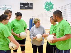 For more than 40 years, Bernie Price has worked for the archdiocese&rsquo;s Catholic Youth Organization and has led the high school youth group at Good Shepherd Parish in Indianapolis. Here, she is pictured in the center of five former members of the youth group who now play volleyball together in the archdiocese&rsquo;s Young Adult Ministry sports program. Katie Mracna, left, Zach Burns, Stacia Smith, Amanda Hubenthal and Greg Kocher reunite with Price. (Submitted photo)