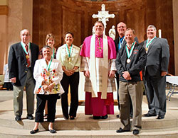 Seven members of the archdiocese received the Catholic Youth Organization&rsquo;s highest honor&mdash;the St. John Bosco Medal&mdash;from Archbishop Joseph W. Tobin during an awards ceremony at SS. Peter and Paul Cathedral in Indianapolis on May 4. Medal recipients Elaine Alhand and Mark Gumbel are in the first row. In the second row, posing with Archbishop Tobin are Bill Sylvester, left, Patty Koors, M.J. Stallings, Joe Matis and Dan Lutgring. (Submitted photo by Christine Metzger)