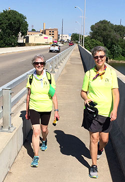 Bev Watt, left, and Monica Robinson smile as they cross the Wabash River on June 10 while on a walking pilgrimage to visit the shrine of St. Theodora Gu&eacute;rin in her shrine at Saint Mary-of-the-Woods. (Submitted photo by Jim Recasner)