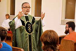 Father Joseph Moriarty gives a homily during a June 16 Mass at the chapel of Bishop Simon Brut&eacute; College Seminary in Indianapolis during Bishop Brut&eacute; Days, an annual summer vocations camp and retreat experience for teenage boys. Father Moriarty, who previously served as the archdiocesan-sponsored seminary&rsquo;s vice rector, was recently appointed its rector, succeeding Father Robert Robeson, who served as rector since its founding in 2004. (Photo by Sean Gallagher)