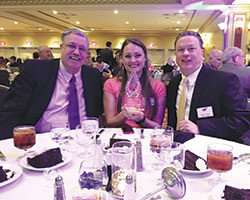 St. Elizabeth Catholic Charities of New Albany&rsquo;s immediate past advisory council chairman Ken Johnson, left, social services director Leslea Townsend Cronin and agency director Mark Casper pose with the Non-Profit of the Year Award that their organization won at the One Southern Indiana annual meeting on Aug. 16. (Submitted photo)