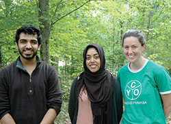 In early August, the archdiocese&rsquo;s Catholic Youth Organization (CYO) camp in Brown County became the setting for about 150 Muslim youths from across the country to enjoy a week of swimming, canoeing, climbing and learning about their faith. It also became an opportunity for members of the two faiths to learn from each other. Here, two advisers of the Muslim Youth of North America camp, Uzair Siddiqui, left, and Fariha Hossain, pose for a photo with Anne Taube, assistant camp director of the CYO&rsquo;s Camp Rancho Framasa. (Photo by John Shaughnessy)