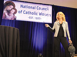Motivational speaker Judy Hehr uses a ball and chain as a prop to illustrate the feelings of imprisonment that plagued her for decades following childhood abuse and other traumas. Her realization of God&rsquo;s mercy was her turning point, she told hundreds of participants at the National Council of Catholic Women&rsquo;s annual convention in Indianapolis on Sept. 9. (Photos by Victoria Arthur)