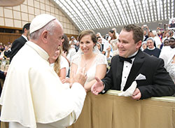 Elisabeth and Scott Williams of St. John the Evangelist Parish in Indianapolis smile in complete joy as they meet Pope Francis at the Vatican on August 3. The couple was married in St. Luke the Evangelist Church in Indianapolis on May 28, and later traveled to Rome after they learned about the long-standing tradition of popes offering a blessing to newlyweds. (Photo courtesy of L&rsquo;Osservatore Romano) 