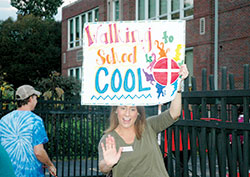 St. Thomas Aquinas School teacher Kate Krieger welcomes students with a high-five as they come to school on Oct. 5, &ldquo;National Walk to School Day.&rdquo;  The Indianapolis North Deanery school is one of only four Catholic schools across the country to earn the 2016 Let&rsquo;s Move! Active Schools National Award. (Photo by John Shaughnessy)