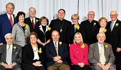 Eighteen people were honored for their contributions to the Mother Theodore Catholic Academies in Indianapolis during a 10-year anniversary celebration on Oct. 27. Seated from left are Richard Ruwe, Connie Zittnan, George Zittnan, Catherine Elder and Tim McGinley. Standing from left are Art and Ann Wilmes (accepting for Archbishop Emeritus Daniel M. Buechlein), William Drew, Jane Drew, Cardinal-designate Joseph W. Tobin, Annette &ldquo;Mickey&rdquo; Lentz, Msgr. Joseph Schaedel, Carole Watt and Tony Watt. Honorees not pictured are Marc and Jennifer Konesco, Charles and Jacqueline Pechette, Bill and Eileen Polian, and Jane McGinley. (Photo by Rob Banayote)