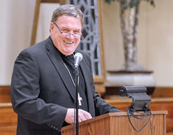 Cardinal-designate Joseph W. Tobin shares a laugh during his comments at the Miter Society Reception at the Archbishop Edward T. O&rsquo;Meara Catholic Center in Indianapolis on Oct. 18. On Nov. 7, he was named to lead the Archdiocese of Newark, N.J. (Criterion photo by Natalie Hoefer)