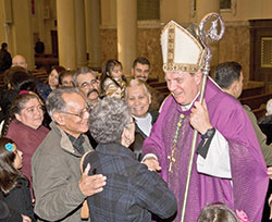 After celebrating Mass at his home parish, Holy Redeemer Church in Detroit, on Nov. 25, 2010, Archbishop Joseph W. Tobin stands in the church&rsquo;s main aisle greeting parishioners for more than a half-hour. Archbishop Tobin was baptized at the church and was its pastor for several years after being ordained a priest. (File photo by Larry A. Peplin, The Michigan Catholic) 
