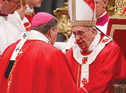 Pope Francis greets Archbishop Joseph W. Tobin of Indianapolis after presenting him with a pallium during a Mass marking the feast of Sts. Peter and Paul in St. Peter&rsquo;s Basilica at the Vatican on June&nbsp;29, 2013. The pope presented woolen palliums to 34 archbishops during the liturgy. (CNS file photo)