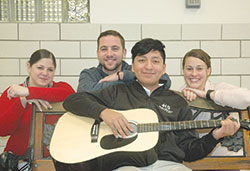 Ethan Velazquez is back enjoying the things he loves&mdash;including playing the guitar&mdash;thanks to the life-saving efforts of three staff members at Holy&nbsp;Spirit School in Indianapolis: Stacy Inman-Davidson, left, Lucas Stippler and Lauren McLaughlin. (Photo by John Shaughnessy)