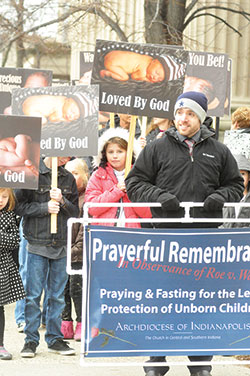 Scott Seibert, marriage and family enrichment coordinator for the archdiocese&rsquo;s Office of Pro-Life and Family Life, prepares to lead a prayerful march in witness to the call for legal protection of the unborn along Meridian Street in Indianapolis on Jan. 23. (Photo by Natalie Hoefer) 