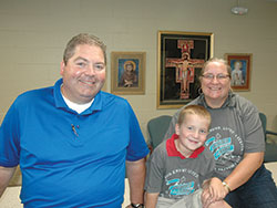 Harold, Gus and Kathy Ducote have found a home&mdash;and a place to live their faith&mdash;at SS. Francis and Clare of Assisi School in Greenwood. (Photo by John Shaughnessy) 