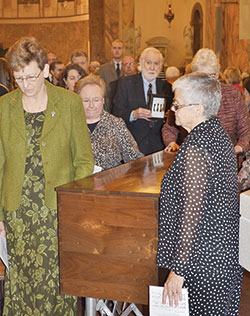 Providence Sister Dawn Tomaszewski, left, walks on Oct. 3, 2014, along a coffin containing the remains of St. Mother Theodore Gu&eacute;rin as it was taken to a new shrine built in her honor on the campus of the motherhouse of the Sisters of Providence of Saint Mary-of-the-Woods. Sister Dawn was elected general superior of the Sisters of Providence on July 3, 2016. Also accompanying the coffin are, from left, Providence Sister Mary Beth Klingel, Tony DuBois, Providence Sister Lisa Stallings (partially obscured) and Providence Sister Denise Wilkinson, general superior at the time. (Photo courtesy of the Sisters of Providence of Saint-Mary-of-the-Woods) 