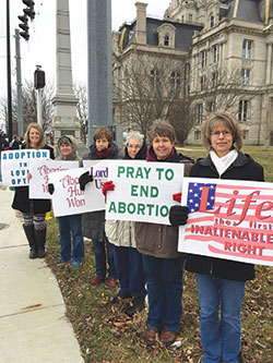Chrysti Stewart, left, Jill Pfister, Ann Welch, Judy March, Doris Fisher and Jennifer Buell hold signs in front of the Vigo County Courthouse in Terre Haute during a prolife observance on Jan. 27. (Submitted photo by Tom McBroom)