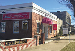 A new Women&rsquo;s Care Center opened in Bloomington immediately next to a Planned Parenthood abortion facility on Feb. 1, seen in the background of this Feb. 15 photo. (Submitted photo by Lee Ann Zatkulak)	
