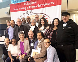 Members of the archdiocesan delegation are pictured with other Indiana delegation members during the Feb. 16-19 World Meeting of Popular Movements regional meeting in Modesto, Calif. Posing from the archdiocese in the front row are: far left, Providence Sister Tracey Horan, a community organizer for Indianapolis Congregation Action Network; fourth from left, Father Christopher Wadelton, pastor of St. Philip Neri Parish in Indianapolis; fifth from left, Juan Perez, a member of Holy Spirit Parish in Indianapolis; and far right, Oscar Castellanos, archdiocesan director of Intercultural Ministry. Back row: fourth from left, Father Kenneth Taylor, pastor of St.&nbsp;Rita and Holy Angels parishes, both in Indianapolis; sixth from left, Araceli Martinez, a member of St. Monica Parish in Indianapolis; and eighth from left, Alma Figueroa, a member of St. Anthony Parish in Indianapolis. Not pictured is Deacon Michael Braun, director of the archdiocesan Secretariat for Pastoral Ministries. (Submitted photo)