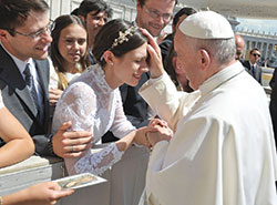 Pope Francis blesses newlywed Katie Rutter and her husband Brian Rutter in St. Peter&rsquo;s Square at the Vatican on May 3. (Photo courtesy L&rsquo;Osservatore Romano)