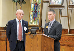 Joe Huelseman, right, an archdiocesan seminarian at Bishop Simon Brut&eacute; College Seminary in Indianapolis, reads a letter of thanks to donor Art Berkemeier of St. Mark the Evangelist Parish in Indianapolis during a Circle of Giving event at the Archbishop Edward T. O&rsquo;Meara Catholic Center on May 4. (Photo by Natalie Hoefer)