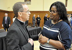 Archbishop-designate Charles C. Thompson speaks with Dabrice Bartet of St. Monica Parish in Indianapolis after his press conference in the Archbishop Edward T. O&rsquo;Meara Catholic Center in Indianapolis on June 13. (Photo by Sean Gallagher)