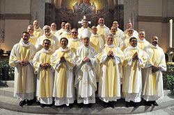 Archbishop-designate Charles C. Thompson poses with 21 newly ordained permanent deacons of the Church in central and southern Indiana on&nbsp;June 24 in SS. Peter and Paul Cathedral in Indianapolis after the Mass in which they were ordained. (Photo by Sean Gallagher)