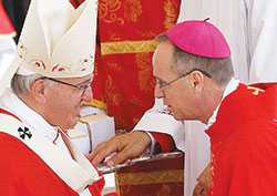 Pope Francis greets Archbishop-designate Charles C. Thompson of Indianapolis as he presents a pallium to the archdiocese&rsquo;s new shepherd during a Mass marking the feast of SS. Peter and Paul in St. Peter&rsquo;s Square at the Vatican on June 29. New archbishops from around the world received their palliums from the pope. The actual imposition of the pallium will take place in his archdiocese. (CNS photo/Paul Haring)